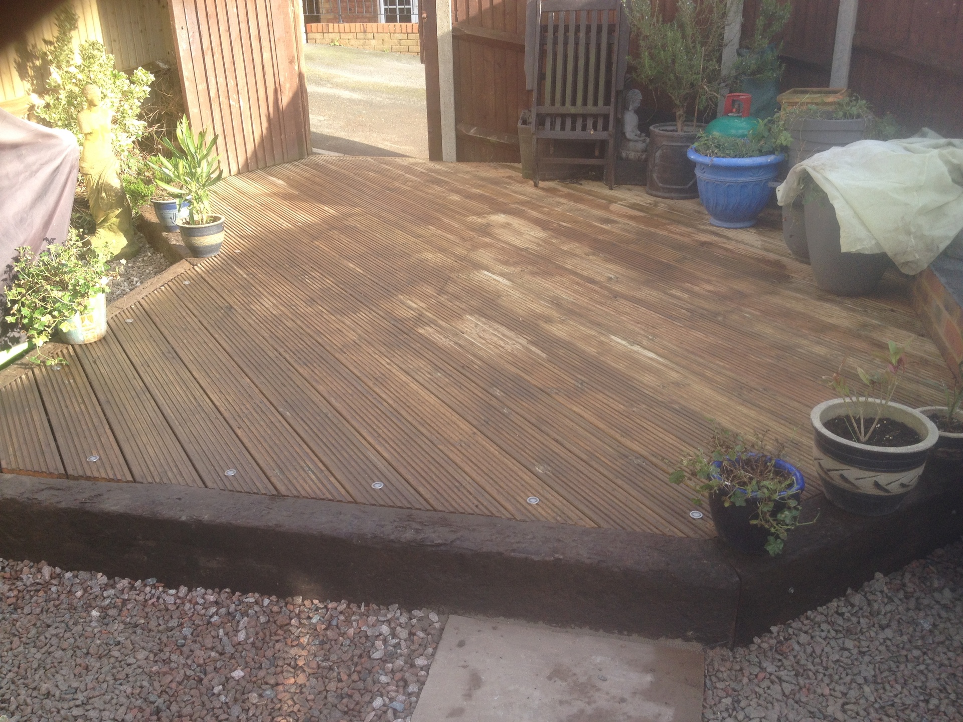 A raised timber deck finished with a gravel border
